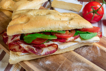 Italian focaccia sandwich with capocollo, lettuce & tomatoes