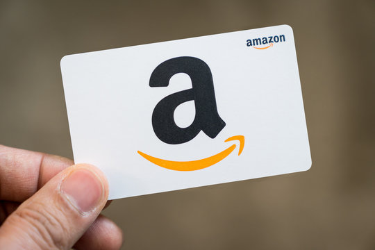 Hand hold an Amazon gift card isolated