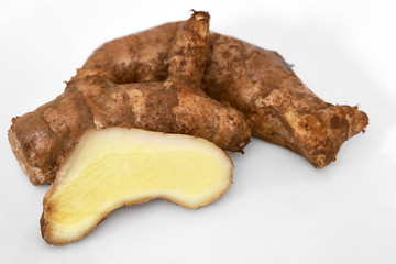 Mango-Ginger rhizome whole and sliced on white