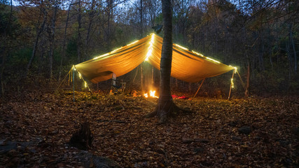 Primitive Tarp Shelter with campfire and fairy lights. Survival Bushcraft setup in the Blue Ridge...