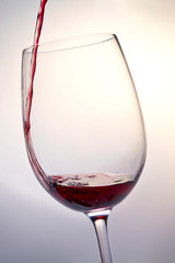 red wine pouring into glass