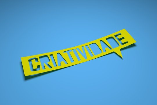 Bubble speech with cut out phrase "Criatividade" in the paper. Criativity in portuguese