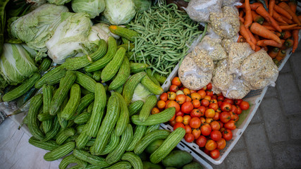 Momordica charantia or bitter melons, tomatoes, cabbage, boontjes, carrot, and other vegetables in the tradisional market from local farmer