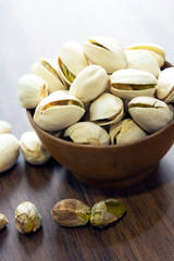 Pistachio nuts on an old wooden background.