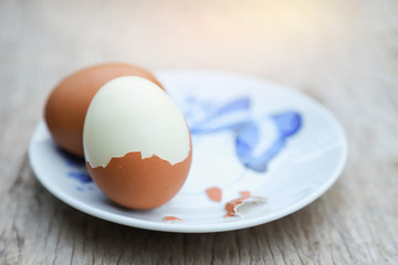 Boiled egg peeling on dish 
