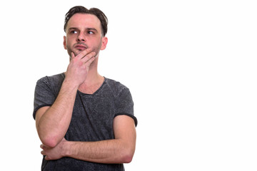 Studio shot of man thinking and looking up