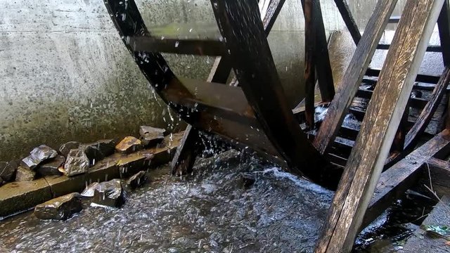 Wooden Water Mill Wheel Spinning. Clouse-up of a Spinning Water Mill. 60 fps.