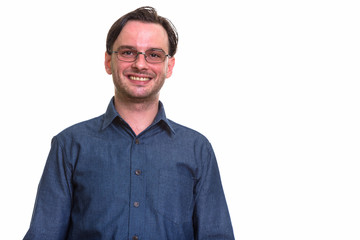 Studio shot of formal young happy man smiling while wearing eyeg