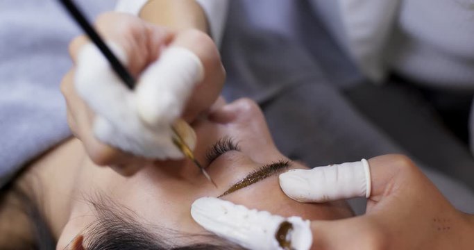 Microblading procedure, master works with the eyebrows