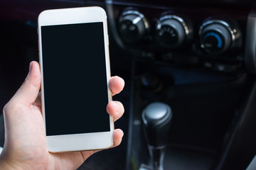 A close up of a hand holding a smartphone in the car for the trip. With copy space.