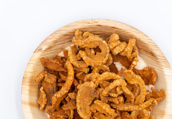 Pork rind , Streaking crispy pork in  dishes made from natural materials on white background.