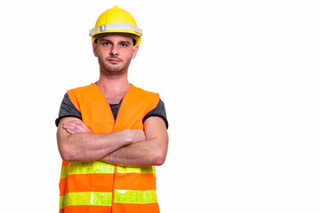 Studio shot of young man construction worker with arms crossed