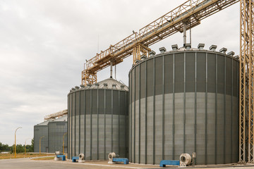 Modern elevator for storing grain against the sky. Grain drying complex, storage and transportation of grain. Large granary in the field. Agricultural industry - obrazy, fototapety, plakaty