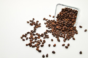 Vitamins of group B, D. Pine nuts in skarlupe on an isolated white background.