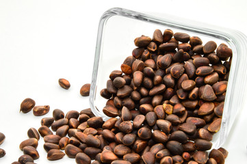 Vitamins of group B, D. Pine nuts in skarlupe on an isolated white background.