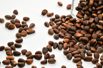 Vitamins of group B, D. Pine nuts in skarlupe on an isolated white background.