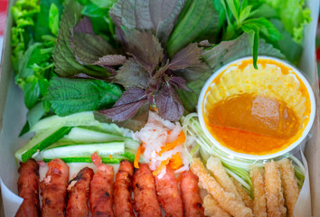 Vietnamese Fresh spring rolls with shrimp, meat, eggs, fish cakes, vegetables, sauces, Vietnamese street food