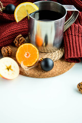 Hot lemon tea in an aluminum mug. Cozy winter red sweater.