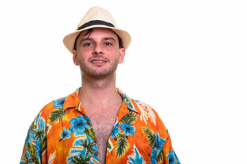 Studio shot of young happy man smiling