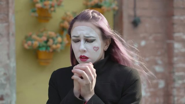 Mime imitates a cough and sore throat.