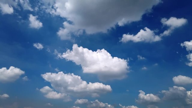 White puffy clouds and blue sky time-lapse with long second duration for background and graphics in daylight. 4K 30fps