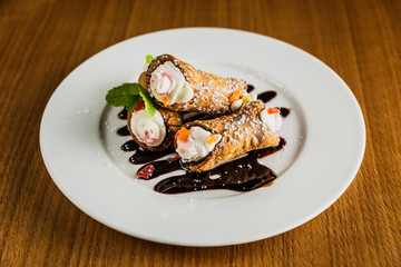 Cannoli dessert with chocolate sauce