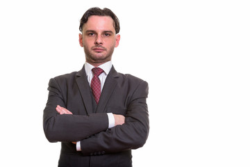 Studio shot of young businessman with arms crossed