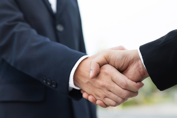 Closeup of a businessman hand shake investor between two colleagues  OK, succeed in business Holding hands.