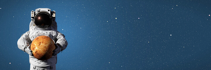 astronaut holding planet Venus