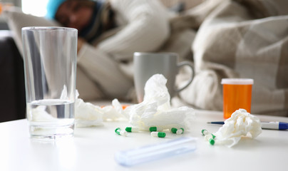 Woman gets sick and lies on a sofa at home suffering