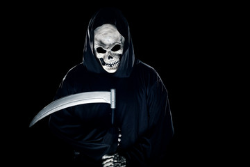 Grim Reaper ghost coming out of the shadows with a scythe or sickle.  The scary demon or monster depicts Halloween and Day of the Dead holiday. - obrazy, fototapety, plakaty