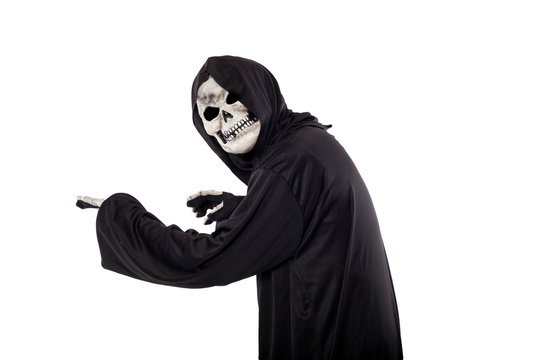 The grim reaper or death halloween costume isolated on a white background.  The skeleton is wearing a hooded black robe. Side view in profile for composites.