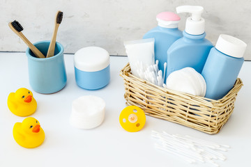 Baby bathroom cosmetics near pacifier and rubber duck on white background