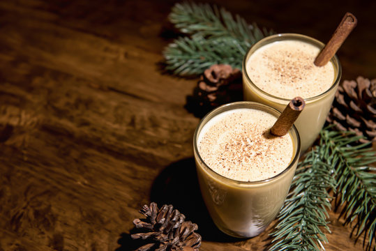 Homemade traditional Christmas eggnog drinks with ground nutmeg and cinnamon