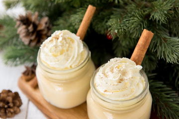 Obraz na płótnie Canvas Traditional Christmas eggnog drinks with whipped cream