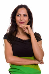 Close up of happy Persian woman smiling and thinking while looking up