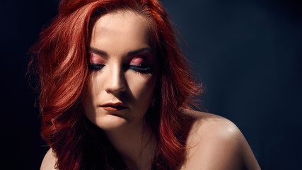 Fototapeta premium Sensual beautiful woman with bright evening makeup and stylish hairdo