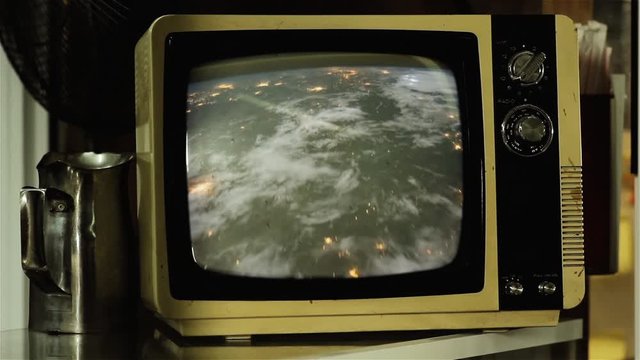 Planet Earth and City Lights from Space, ISS View, on a Retro TV. Zoom In. Elements of this video furnished by NASA.