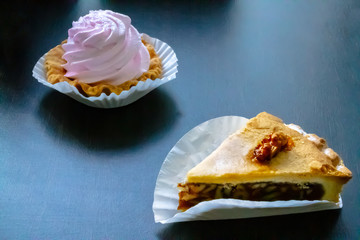 delicate dessert, a basket of light cream of light pink meringue and a nutty piece of cake .
