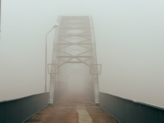 foot bridge in the fog in the fall. Gomel, Belarus