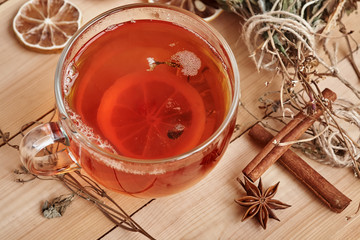 Black tea with slice of lemon in glass cup.