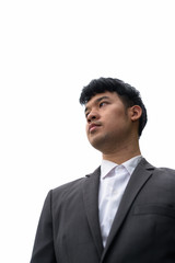 Portrait of young Asian businessman against view of the city