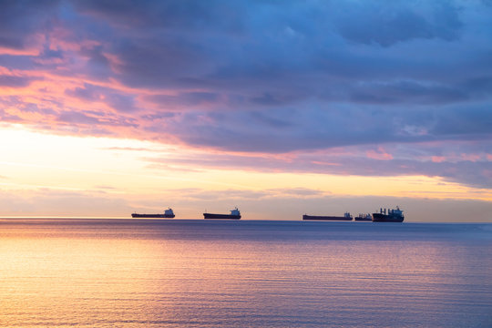 Scene Of Ocean At The Sunset With Cloudy And Ships As Background.Concept Of To Calm Yourself Down From Stress, Depress And Clean Up Mind.Sun Light On The Left Present Bring The Light Of Life Up.