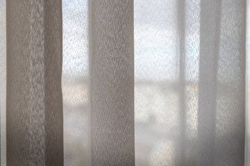 Transparent white curtain on window and city behind it. Curtain background