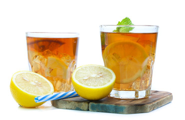 iced tea with lemon slices and mint on white background