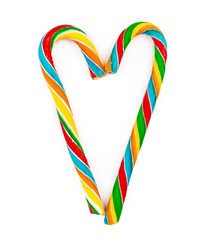 Rainbow colored candy cane isolated on white background