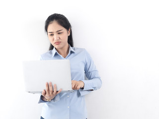 Happy Asian woman using laptop with white wall,lifestyle concept.