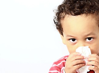 child blowing nose after catching a cold with white background stock photo 