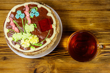 Cup of tea and Kiev cake on a wooden table. Top view