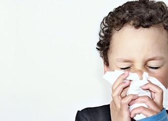 child blowing nose after catching a cold with white background stock photo 